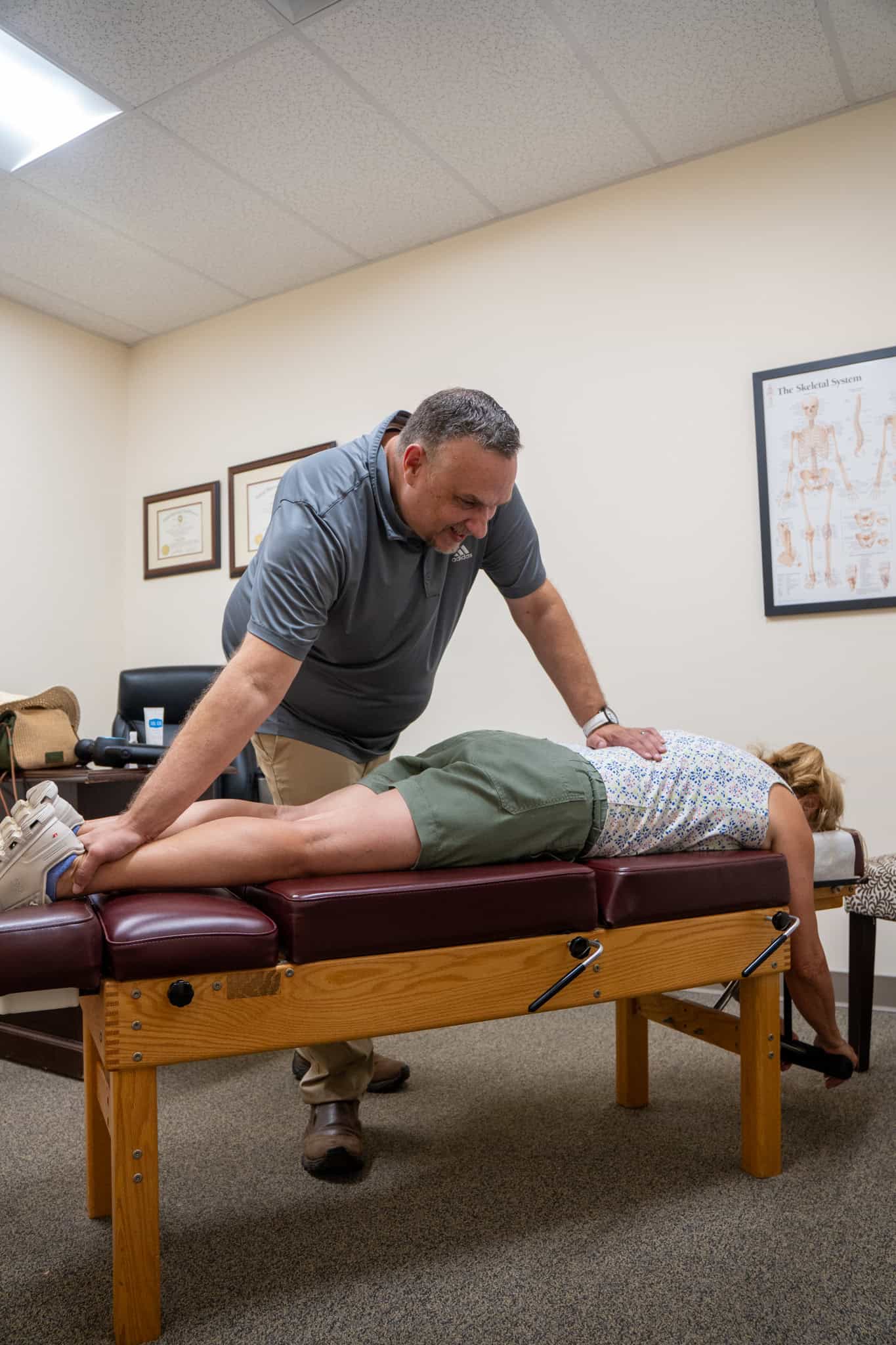 Chiropractor helping patient with a gentle back adjustment